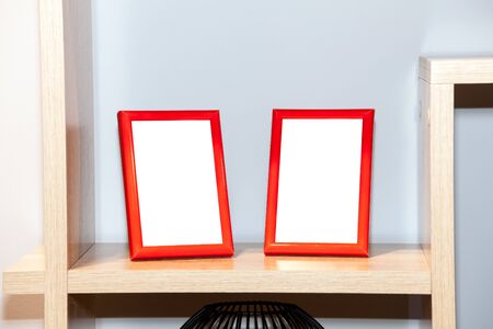 Two blank photo frame on the bookshelf. Mock up of blank photo frame