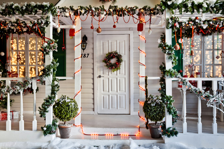 Entrance to the house with porch decorated for christmas and New Year holidayの写真素材