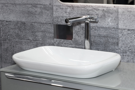 Modern white sink with black ceramic around, bathroom interiorの写真素材