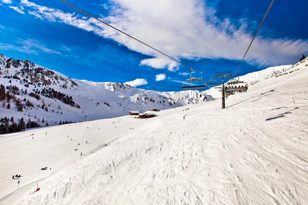 Ski chair lift moving, rope way in Alps mountains in Mayerhofen, Austriaの写真素材