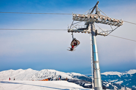 Ski chair lift moving, rope way in Alps mountains in Mayerhofen, Austriaの写真素材