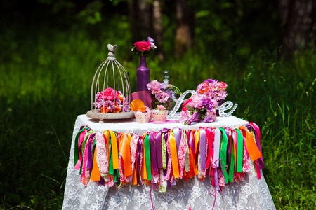 Love wooden sign on the table, wedding decoration with flowers bouquetsの写真素材