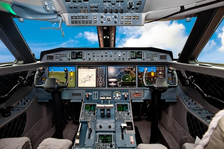 The cockpit of the aircraft with blue sky outsideの写真素材