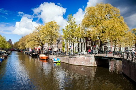 Amsterdam, Netherlands - April, 2017: Sunny spring day in Amsterdam. Canal view with boats and bicycles, Netherlandsのeditorial素材