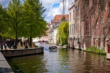Bruges, Belgium - April, 2017: Small boat canal cruise in Brugge city, Belgiumのeditorial素材