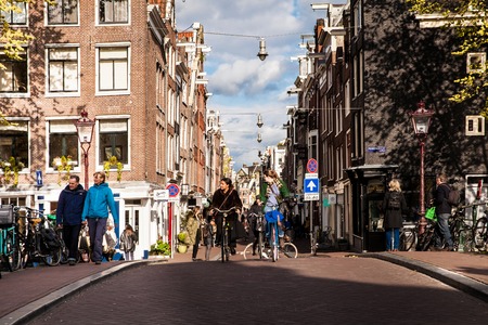 Locals on the bicycles on Amsterdam street. Spring day ath the cityのeditorial素材