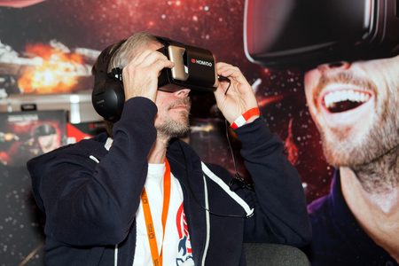 Man playing with Homido virtual reality headset on Robotics Expo in Moscow, Russiaのeditorial素材