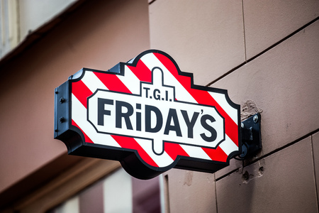 Riga, Latvia - July, 2017: Fridays logo sign in Riga, Latvia. T.G.I. Fridays is an American restaurant chain focusing on casual dining.のeditorial素材