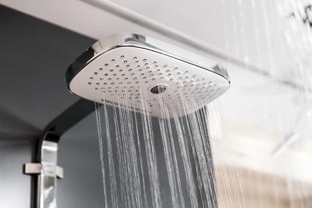 Modern shower with water drops in bath interiorの写真素材