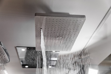 Modern shower with water drops in bath interiorの写真素材