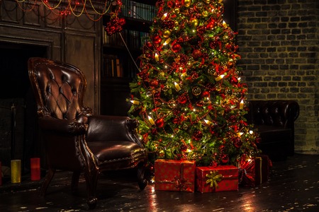 Classic green new year tree in the dark room. Christmas interior backgroundの写真素材