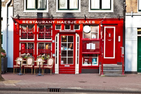 Street cafe with tables outside in Amsterdam city, Hollandのeditorial素材