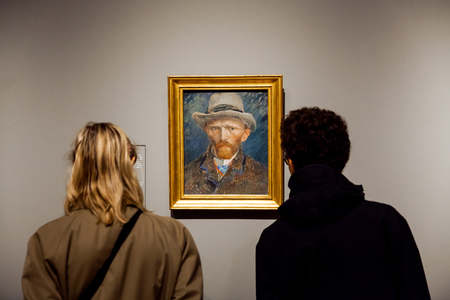 Visitors watching self-portrait artwork of famous painter Vincent van Gogh in Rijsmuseum in Amsterdam city, Holland