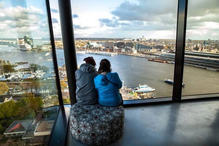 Two people looking on Amsterdam from aerial view, Hollandのeditorial素材