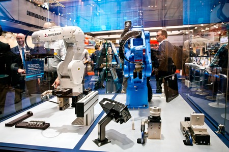 Mitsubishi and Yaskawa robot arms on Schunk stand on Messe fair in Hannover, Germanyのeditorial素材