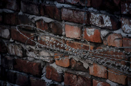Gloomy gray fence of the prison with barbed wire. Consistency in the conclusion. The concept of individual rights and freedoms. Restricted person rightsの写真素材