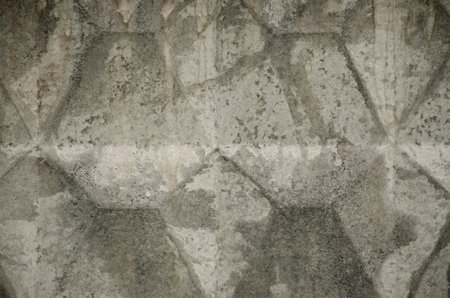 Abstract pattern, gray concrete fence. Concrete trapezoid paver blocks. Design geometric mosaic...