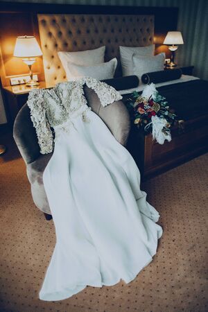 wedding dress and bouquet in the hotel room accecories
