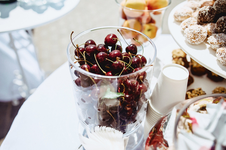 purple cherries on a wedding buffet table outsideの写真素材
