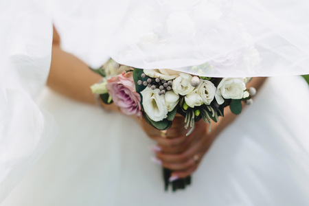 the bride holds a wedding bouquet in her hands, wedding day flowersの写真素材