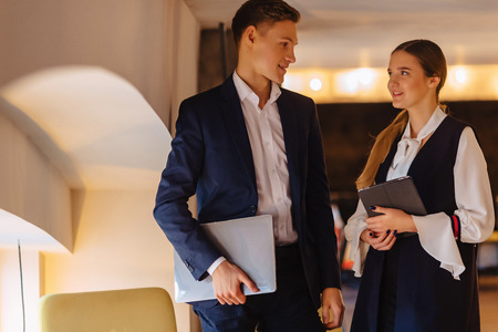 young businessmen guy and girl in a cozy interior have agreed, business and freelance in business styleの写真素材