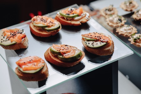 delicious festive buffet with canape and different delicious meals salted and sweetの写真素材