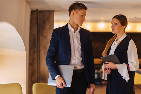 young businessmen guy and girl in a cozy interior have agreed, business and freelance in business styleの写真素材