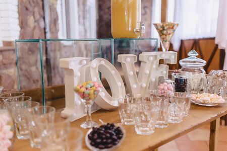 sweet festive buffet, fruit, caps, macaroni and lots of sweets well decoratedの写真素材