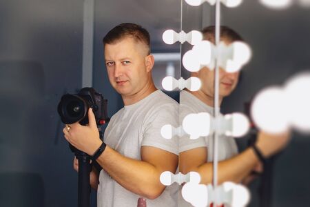 cameraman with a camera on a mono-pod at shooting