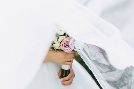 the bride holds a wedding bouquet in her hands, wedding day flowersの写真素材