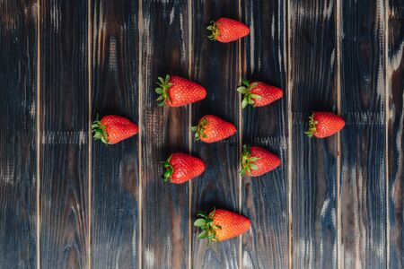 strawberries on a wooden board. pattern of fruits. natural foods.の写真素材