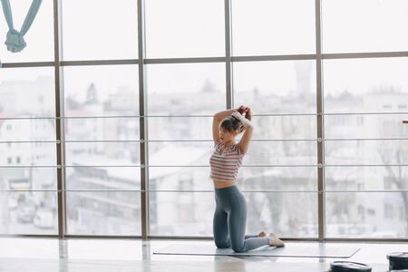 young attractive girl doing yoga, sports and healthy lifestyles, the concept of mental balanceの写真素材