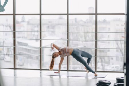 young attractive girl doing yoga, sports and healthy lifestyles, the concept of mental balanceの写真素材