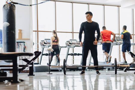 a stylish guy in the gym pulls the barbell. Healthy Lifestyle. training.の写真素材