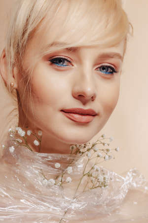 pretty attractive girl with blond hair, fashion shooting, rose, simple background, studioの写真素材