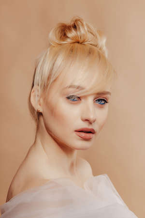 pretty attractive girl with blond hair, fashion shooting, rose, simple background, studioの写真素材