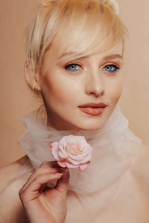 pretty attractive girl with blond hair, fashion shooting, rose, simple background, studioの写真素材