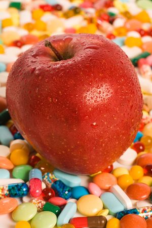 Vertical image of red apple lying on the tabletsの写真素材