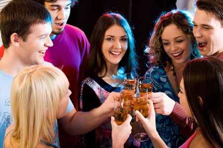 Group are holding the glasses of champagne making a toast
