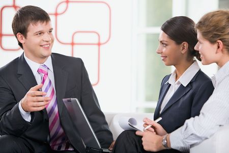 Group of three young business people are discussing new planの写真素材