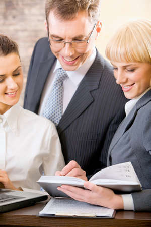 Portrait of three confident white collar office planning their workの写真素材