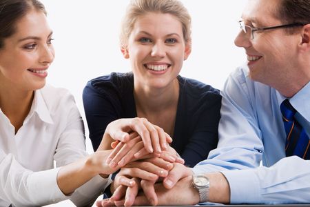 Business team putting their hands on top of each other