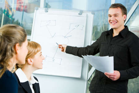Portrait of successful business man doing a presentation at meeting の写真素材