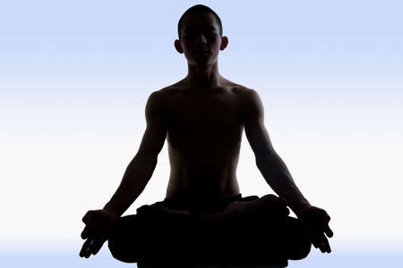 Image of man doing yoga on a blue background の写真素材