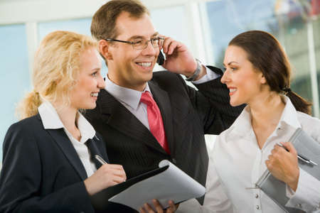 Group of three businesspeople are discussing important questionsの写真素材