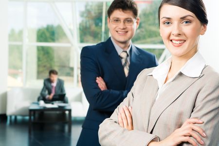 Portrait of two confident partners folding their hands in the room 