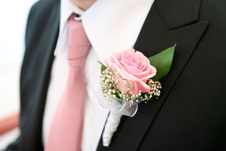 Image of beautiful pink rose on the groomÂs suit の写真素材