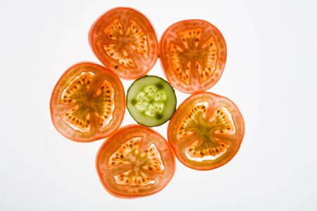 Larger pieces of tomato surround cucumber slice