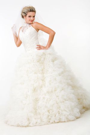 Image of elegant bride in fashionable white wedding gown posing before cameraの写真素材