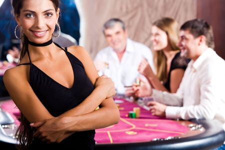 Portrait of fashion woman in black dress in the casino の写真素材